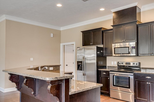 kitchen featuring light wood-style flooring, stainless steel appliances, a breakfast bar, ornamental molding, and light stone countertops