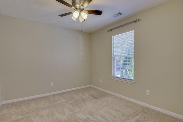 empty room featuring light carpet and ceiling fan