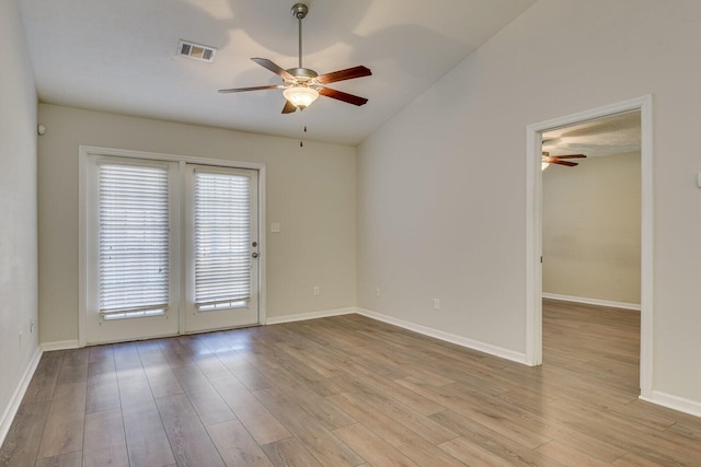 empty room featuring vaulted ceiling, ceiling fan, and light hardwood / wood-style flooring