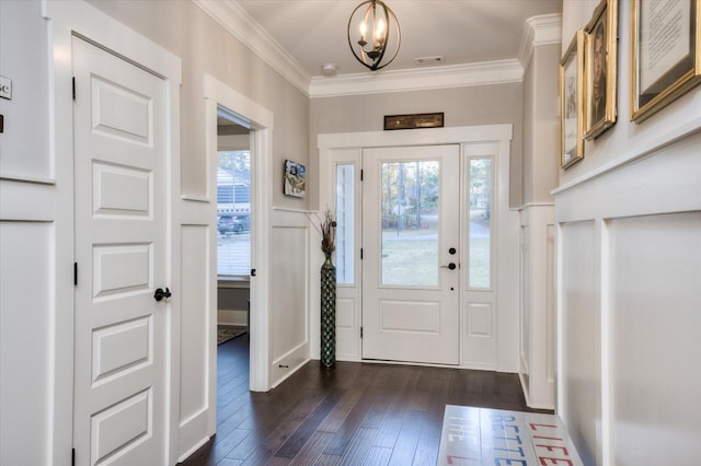 entryway featuring a notable chandelier, crown molding, and dark wood-type flooring