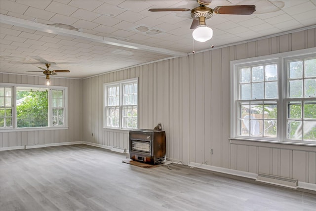 1917 Lazenby Dr, Augusta, GA 30906 - unfurnished room with a wood stove, wood finished floors, and ceiling fan