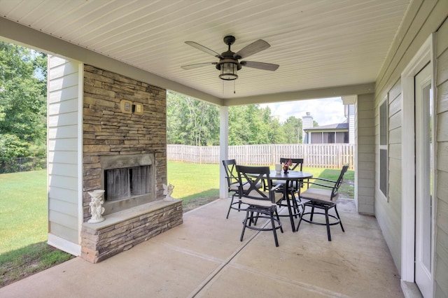 729 Houston Lake Dr, Evans, GA 30809 - fenced backyard featuring an outdoor stone fireplace, outdoor dining space, a patio area, and ceiling fan
