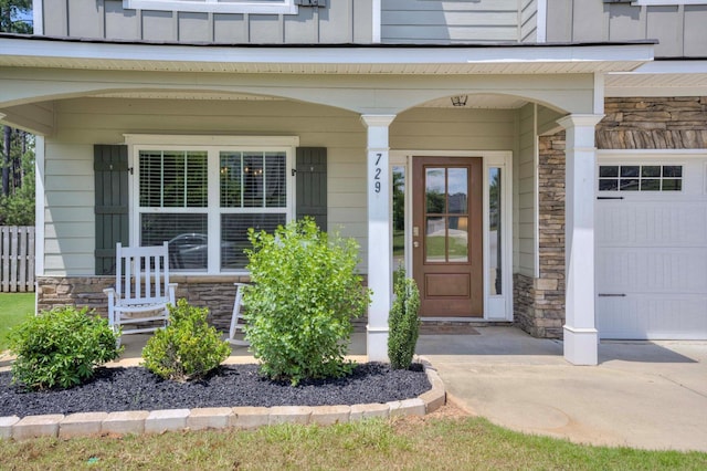 729 Houston Lake Dr, Evans, GA 30809 - doorway to property featuring stone siding, covered porch, and board and batten siding