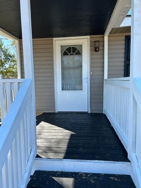 doorway to property featuring a porch