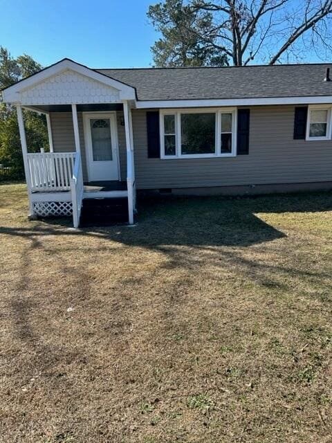 view of front facade with a front yard and a porch