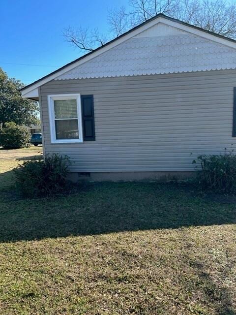 view of property exterior with a lawn