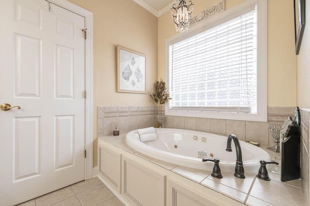 full bath with a whirlpool tub, plenty of natural light, ornamental molding, and tile patterned floors