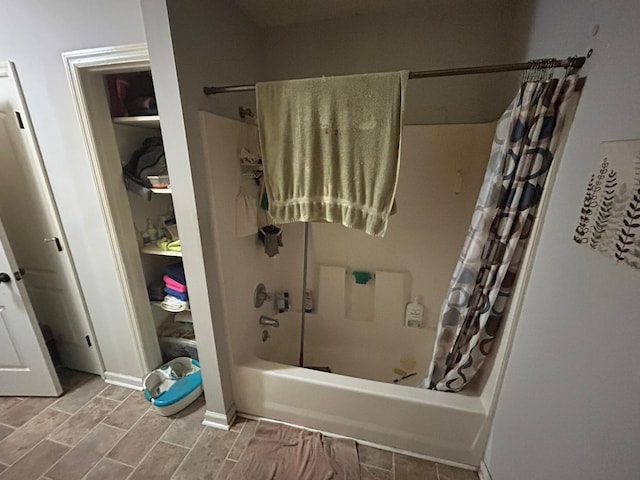 full bath featuring wood finish floors and shower / tub combo