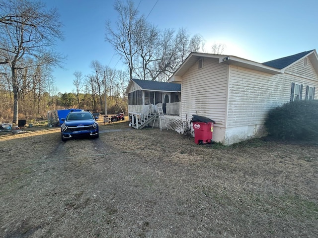 view of home's exterior featuring crawl space and a sunroom