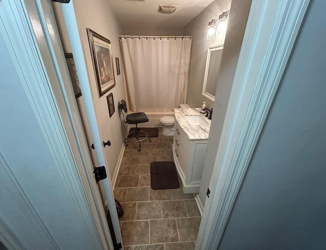 bathroom featuring visible vents, toilet, shower / tub combo, and vanity