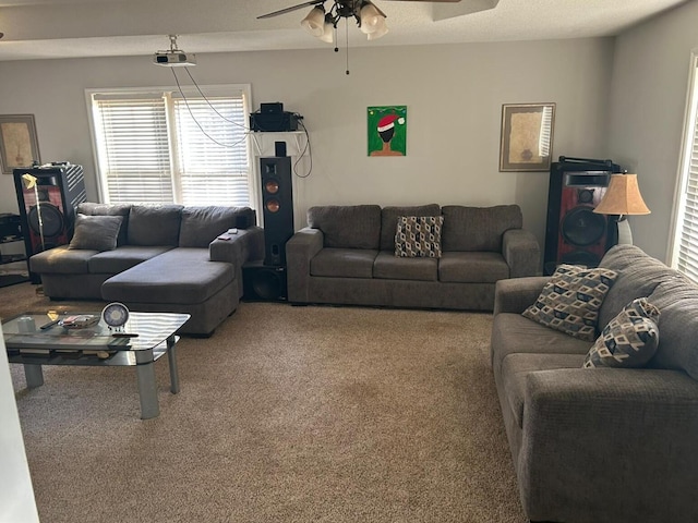 carpeted living room with ceiling fan