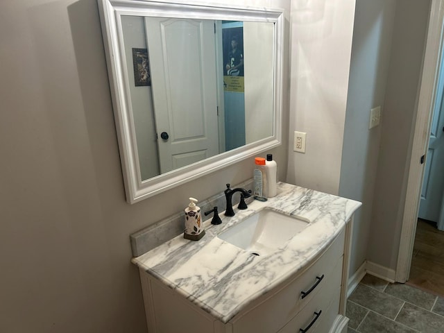 bathroom with baseboards and vanity