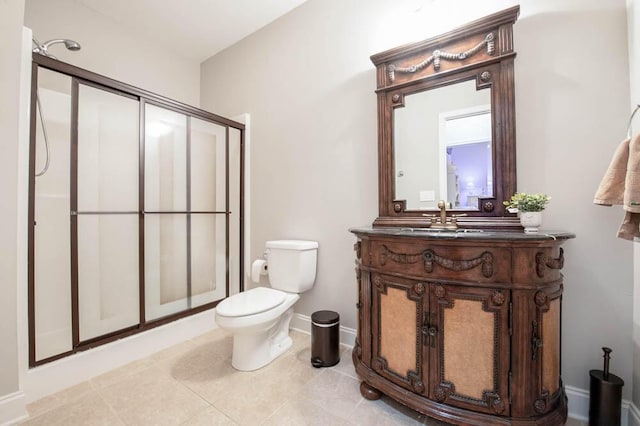 bathroom with tile patterned floors, vanity, toilet, and a shower with shower door