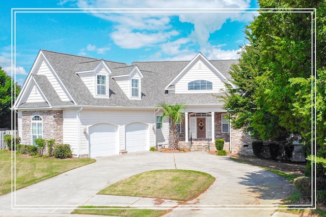 view of front of home with a front yard and a garage