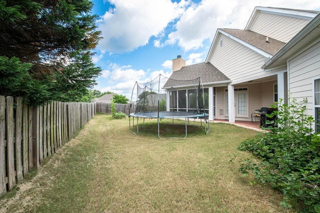 view of yard featuring a patio and a trampoline