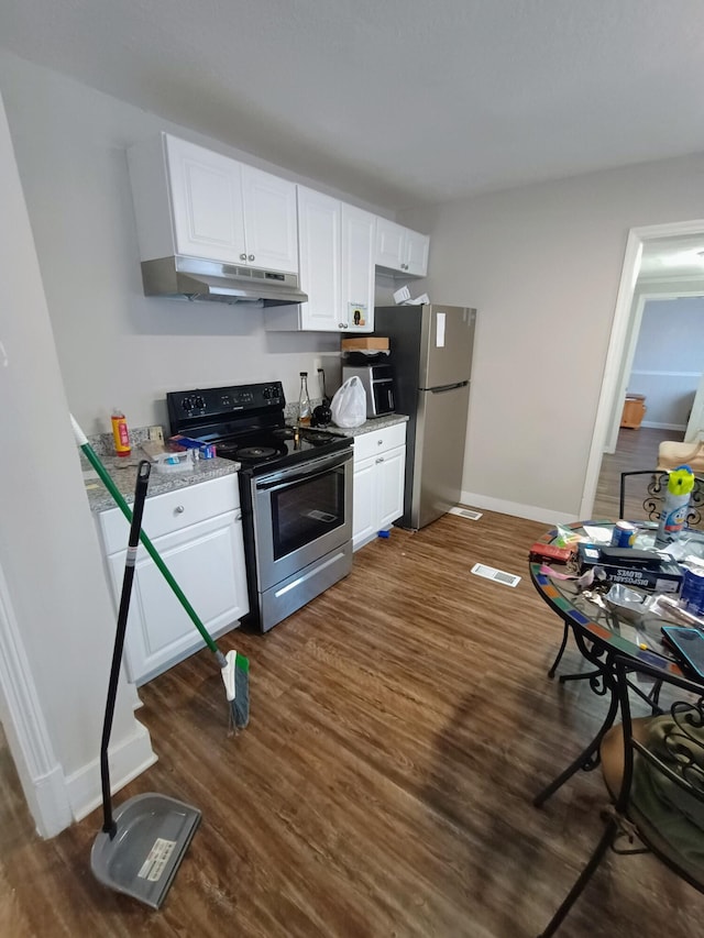 kitchen with under cabinet range hood, white cabinets, appliances with stainless steel finishes, and dark wood-style flooring