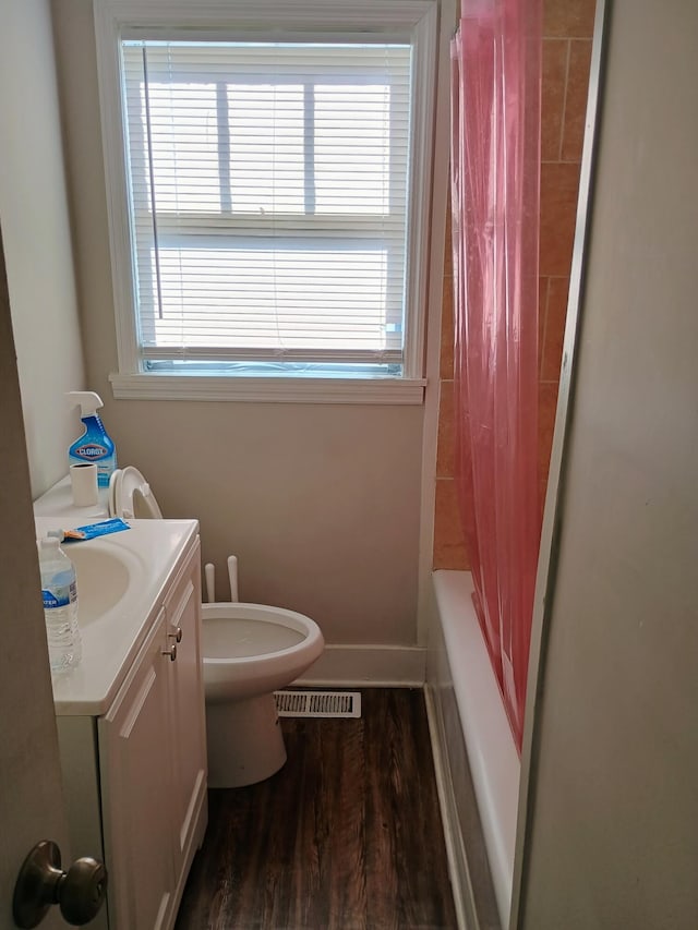 full bathroom featuring visible vents, toilet, wood finished floors, baseboards, and vanity