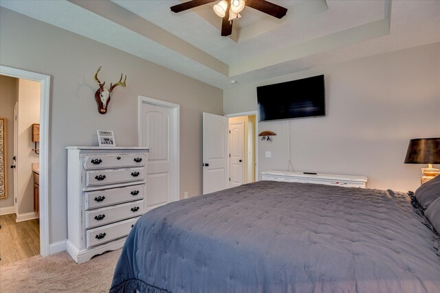 132 Running Creek Dr, North Augusta, SC 29860 - bedroom with baseboards, a raised ceiling, light colored carpet, ceiling fan, and ensuite bath