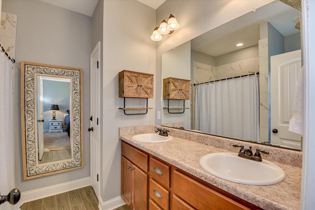 132 Running Creek Dr, North Augusta, SC 29860 - full bathroom featuring double vanity, wood finished floors, baseboards, and a shower with shower curtain