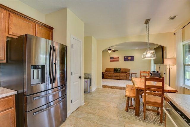 132 Running Creek Dr, North Augusta, SC 29860 - kitchen featuring stainless steel appliances, arched walkways, a ceiling fan, brown cabinetry, and open floor plan
