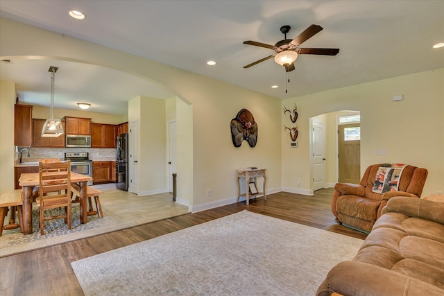 132 Running Creek Dr, North Augusta, SC 29860 - living room with arched walkways, ceiling fan, light wood-style flooring, baseboards, and recessed lighting