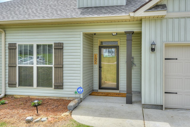 132 Running Creek Dr, North Augusta, SC 29860 - view of exterior entry featuring roof with shingles, board and batten siding, and a garage