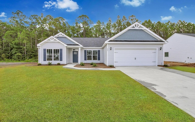 view of front of house with a front yard and a garage