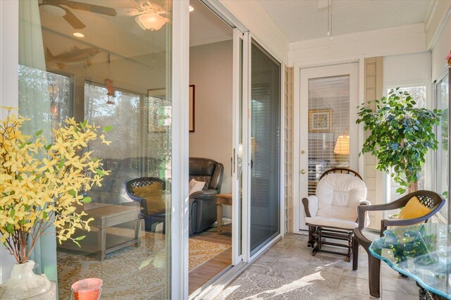 sunroom featuring ceiling fan