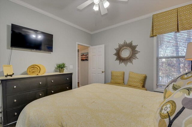 bedroom with ceiling fan and crown molding