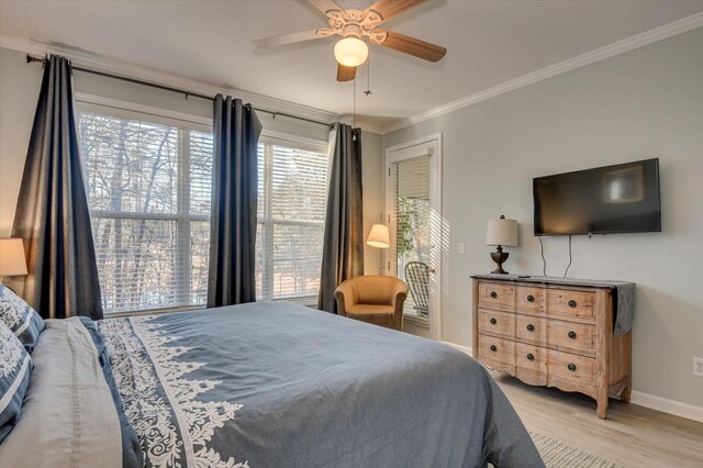 bedroom with light hardwood / wood-style floors, ceiling fan, and ornamental molding