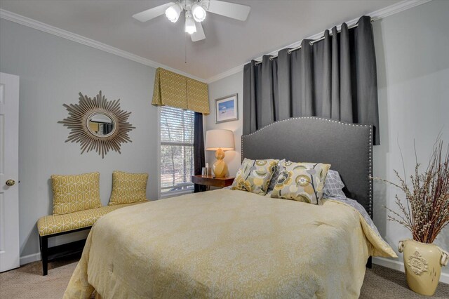 carpeted bedroom featuring ceiling fan and crown molding