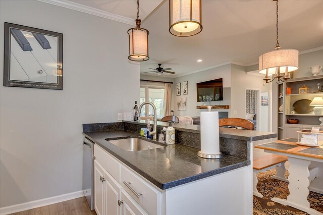 kitchen featuring ceiling fan, sink, pendant lighting, dishwasher, and white cabinets