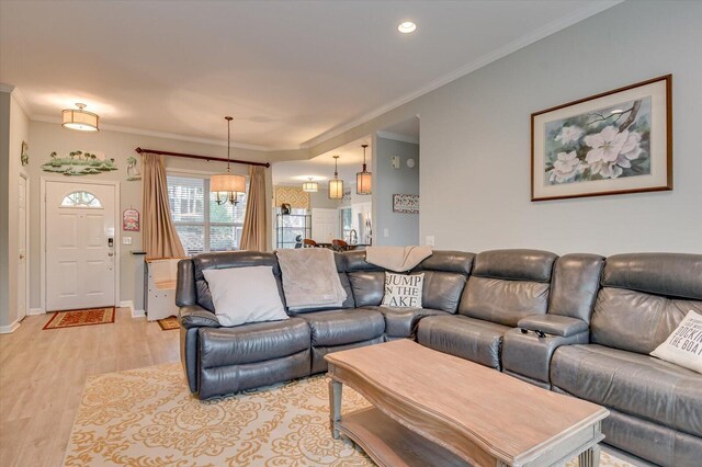 living room with light hardwood / wood-style floors and ornamental molding