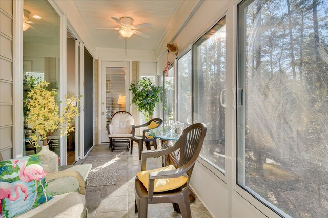 sunroom with ceiling fan and a wealth of natural light