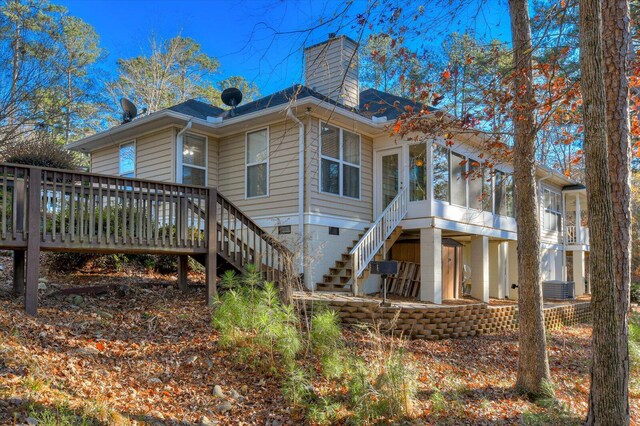 back of house featuring a deck, cooling unit, and a sunroom