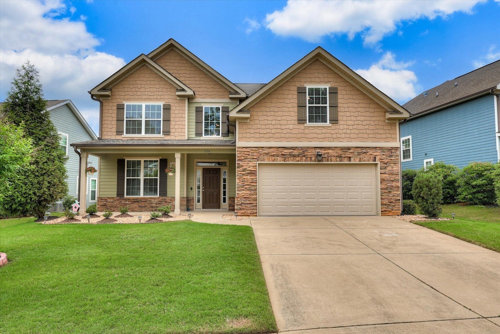 554 Bunchgrass St, Evans, GA 30809 - craftsman-style house with an attached garage, driveway, a front yard, and stone siding