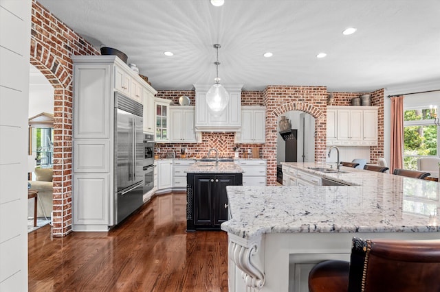 462 Armstrong Way, Evans, GA 30809 - kitchen with a spacious island, a sink, recessed lighting, built in refrigerator, and dark wood-style floors