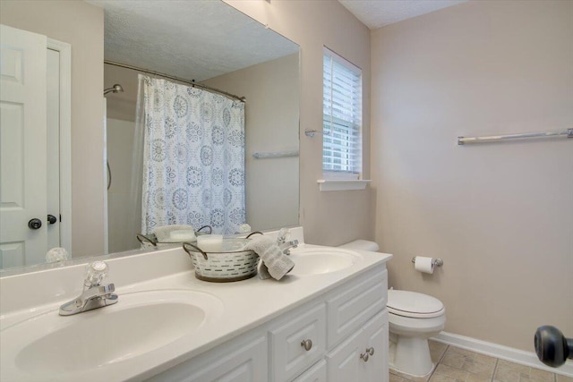 bathroom with walk in shower, tile patterned floors, a textured ceiling, toilet, and vanity