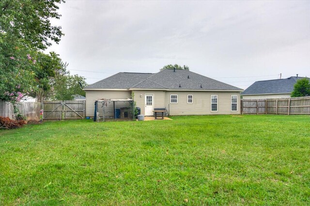 rear view of house featuring a lawn