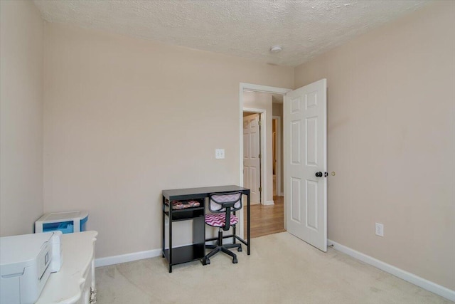 office area with light carpet and a textured ceiling