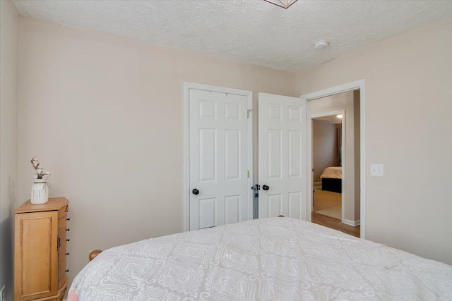 bedroom with a closet and a textured ceiling