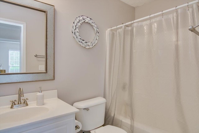 full bathroom featuring shower / tub combo, vanity, and toilet