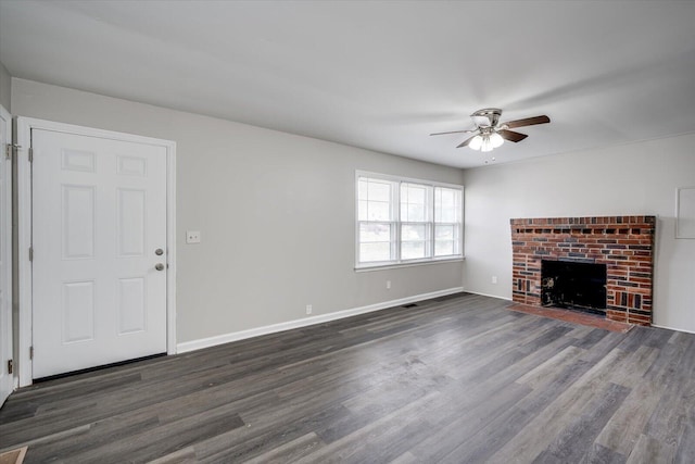 unfurnished living room featuring dark wood-style floors, baseboards, ceiling fan, and a fireplace