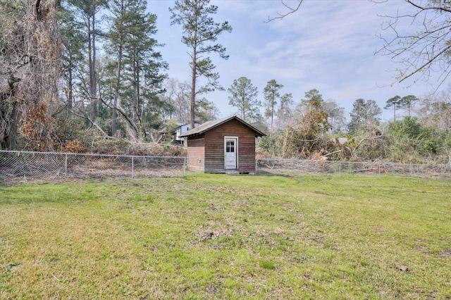 view of yard with an outbuilding, a storage shed, and a fenced backyard