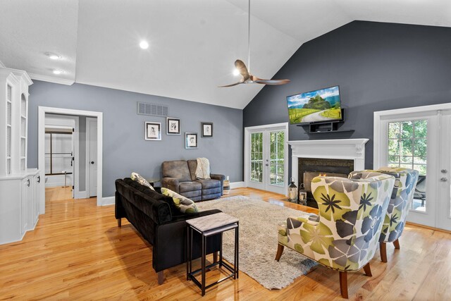 living room with ceiling fan, french doors, plenty of natural light, and light wood-type flooring