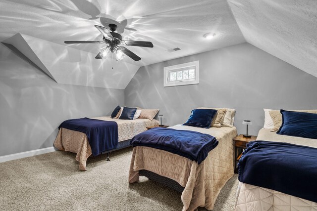 bedroom with a textured ceiling, vaulted ceiling, and ceiling fan