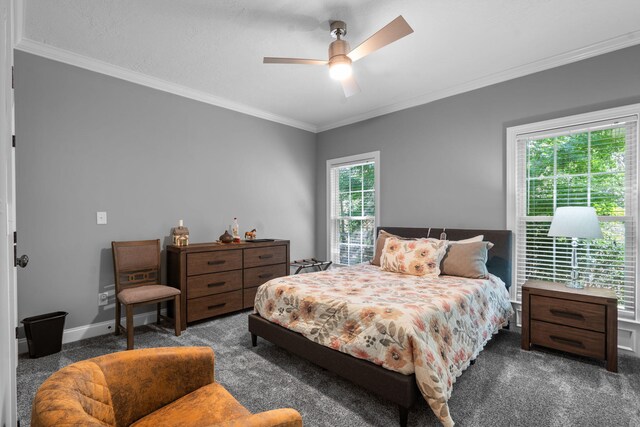 carpeted bedroom featuring multiple windows, ceiling fan, and crown molding