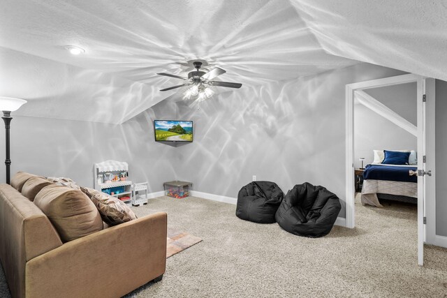 living room with carpet, ceiling fan, a textured ceiling, and vaulted ceiling