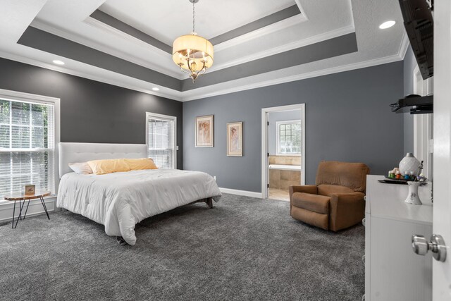 carpeted bedroom with multiple windows, connected bathroom, and a tray ceiling