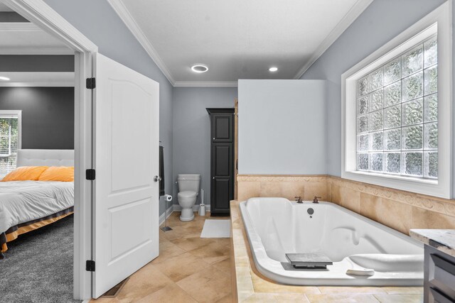 bathroom with vanity, tiled bath, toilet, and ornamental molding